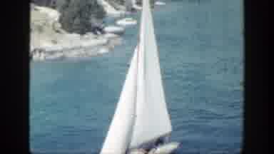 New York (1948): White Sailboats And Other Boats Sailing In A Canal Between A Town