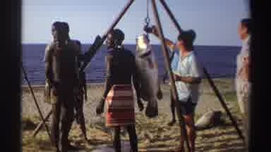 Nigeria (1969): People Gathered On The Shore Around A Fish Hanging From Wood