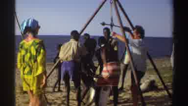 Nigeria (1969): Black Laborers Lift A Huge Fish On A Metal Tripod As White
