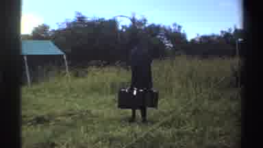 Nigeria-1969: Man Walking With Suitcases Toward Tent