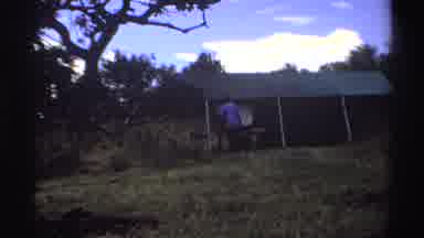 Nigeria (1969): People Walking Around In A Rustic Field Barn And Or Tent