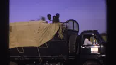 Nigeria (1969): People On Top Of A Truck Passing Through A Dirt Road Surrounded By