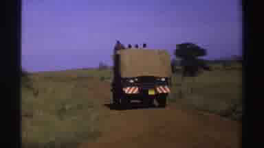 Nigeria (1969): View Of Departing Tan Truck On Dirt Road On A Bright Sunny Day