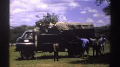 Nigeria (1969): Men Unpack Items From A Loaded Military Truck In The Middle Of A