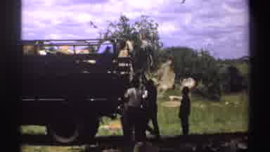 Nigeria (1969): People Taking An Item Off The Back Of A Large Truck
