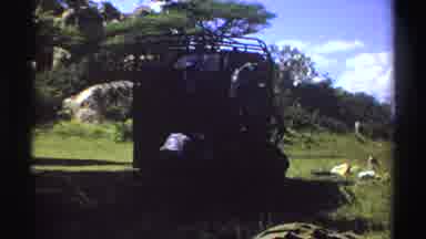 Nigeria (1969): People Unloading Items From Truck On A Bright Sunny Day