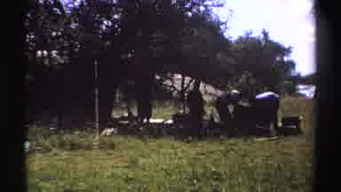 Nigeria (1969): Four People Working In Shade Under A Tree Near Tall Grass On A