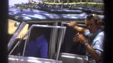 Kenya (1969): Man Wearing Grey Shirt Talks To Person Wearing Blue Shirt Sitting In