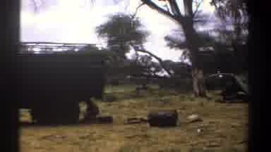 Kenya (1969): A Person Working Underneath A Large Truck Followed By Someone
