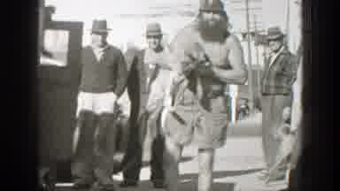 California-1939: Homeless Man Cuddling A Stray Dog On Street