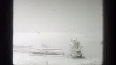 California (1939): View Of White Rotating Harvester Blade And People Walking In