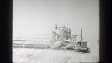 California (1939): A Bulldozer Pulls A Combine With Workers On Top Across A Wheat