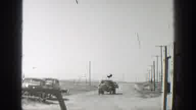 California (1939): Trucks Driving Loaded With Cargo On A Dusty Dirt Road