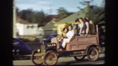 California (1939): Man Driving Vintage Car Carrying Girls Around Town People