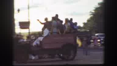 California (1939): People Riding In Back Of Brown Truck On A Clear Day