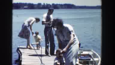 Wisconsin-1953: Father And Mother Teaching Child To Fish Near The Lake