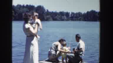 Wisconsin-1953: A Young Family Fishing Off A Dock On A Lake