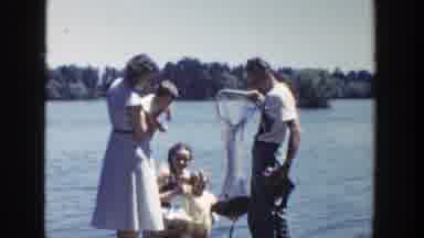 Wisconsin (1953): Two Women With Toddlers Stand On A Dock With A Man While One