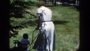 Wisconsin (1953): A Woman Is Seen Walking Her Toddler In A Cradle While A Man