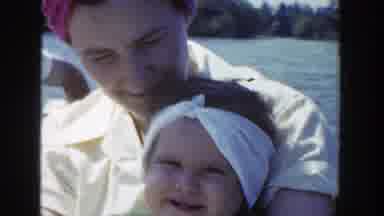 Wisconsin (1953): Woman Wearing Yellow Dress Holds Small Girl Wearing White