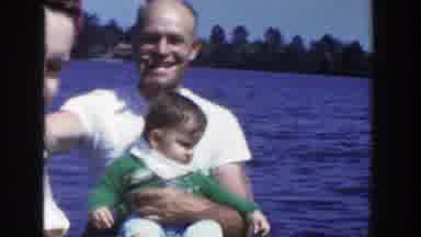 Wisconsin (1953): Outside People On The Water A Bridge With Car Driving On It