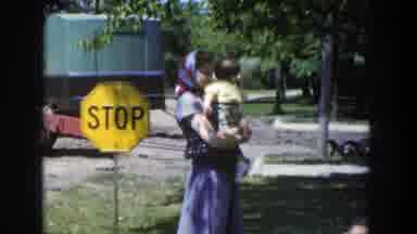 Wisconsin (1953): A Veiled Woman Holding Her Baby As She Watches Another Woman