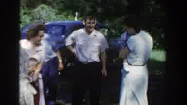 Wisconsin (1953): Man Wearing White Shirt Shaking Hands Of People Standing Near