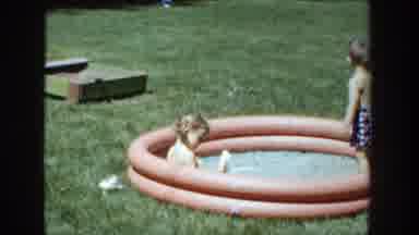 Wisconsin (1953): A Small Girl And Boy Dressed In Bathing Suits Relax In A Small