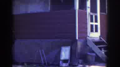 Wisconsin (1953): Red Single Family Home With An Old Vehicle Parked Out Front