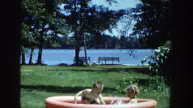 Wisconsin (1953): Young Child Splashes In Kiddie Pool With Sister And Struggles