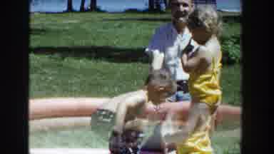 Wisconsin (1953): A Young Boy And Girl Playing In A Kiddie Pool In A Park