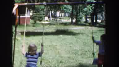 Wisconsin (1953): Children Playing On Swing In Grassy Location With Many Trees In