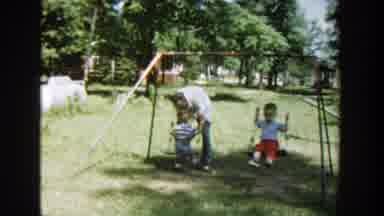 Wisconsin (1953): Two Kids On The Swings With On Adult Pushing The Child In The
