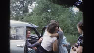 Wisconsin (1953): Group Of People Hugging And Talking Next To A Car