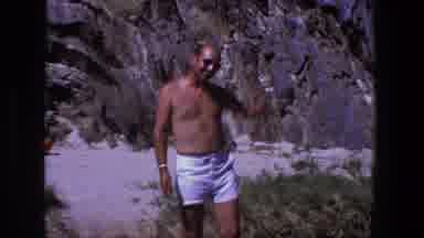 Utah (1969): Man Wearing White Shorts Points At Grey Rock On A Bright Sunny Day