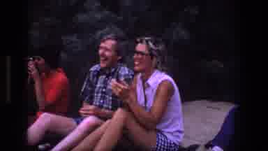 Utah (1969): Man Wearing Dark Grey Pants Runs Towards Light Grey Rocks On A Cloudy