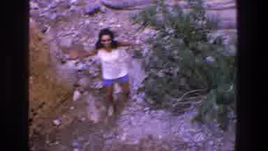 Utah (1969): Woman In A River With Stones Approaches A Man Sitting On A Large Rock