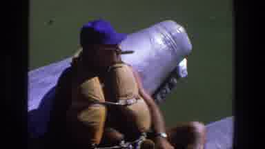 Utah (1969): Man Enjoys A Boat Ride Wearing A Life Jacket And A Bone