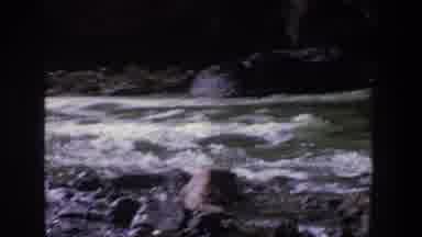Utah (1969): People Standing On Grey Rocks Looking At Rushing River On A Bright