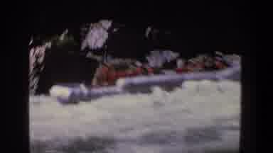 Utah (1969): A Rubber Boat Filled With People In Red Moving Along The Water Waves