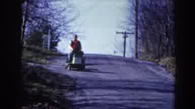 Pequot Lakes Minnesota (1964): Father And Son Driving An Old Toy Car On An Empty