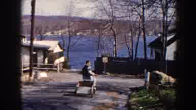 Pequot Lakes Minnesota (1964): Person Wearing White Sweater Rides Green And White