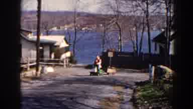 Pequot Lakes Minnesota (1964): View Of Man Wearing White And Black Sweater Riding