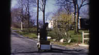Pequot Lakes Minnesota (1964): Two Women On A Motorized Cart That Is Pulling A