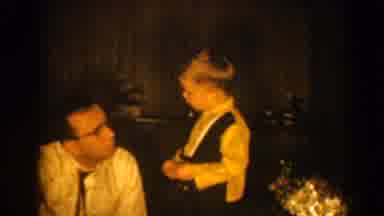 Pequot Lakes Minnesota (1964): Man Wearing Glasses Talks To Small Boy Wearing