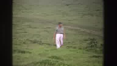 South Africa (1969): Man In Short Sleeve Shirt And White Pants Walking Through A