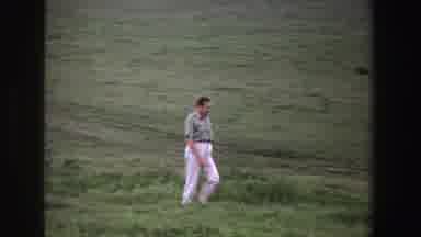 South Africa (1969): A Lone Well Dressed Man Walks Across A Field With Animals In