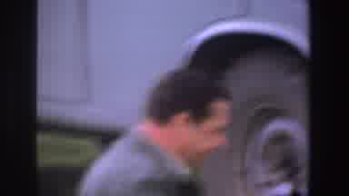 South Africa (1969): Man Changing Tire Of His Car Bottles On A Cloth In The Grass