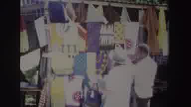 South Africa (1969): Lady In Hat And Shorts Approaches Colorful Tapestry Store