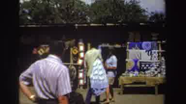 South Africa (1969): Person Wearing Green Hat Walks To Display Shelf At Outdoor